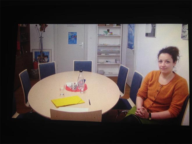 Donka Dimova* in her conference room/hallway, screenshot from HD video