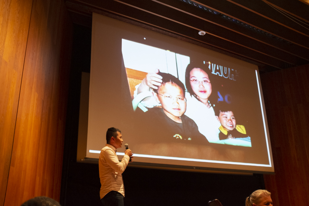 Participant shares a projected childhood photo onstage